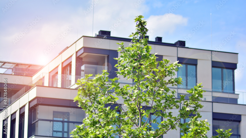 Modern apartment buildings on a sunny day with a blue sky. Facade of a modern apartment building. Gl