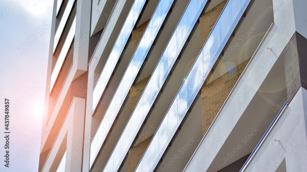 Modern apartment buildings on a sunny day with a blue sky. Facade of a modern apartment building. Gl