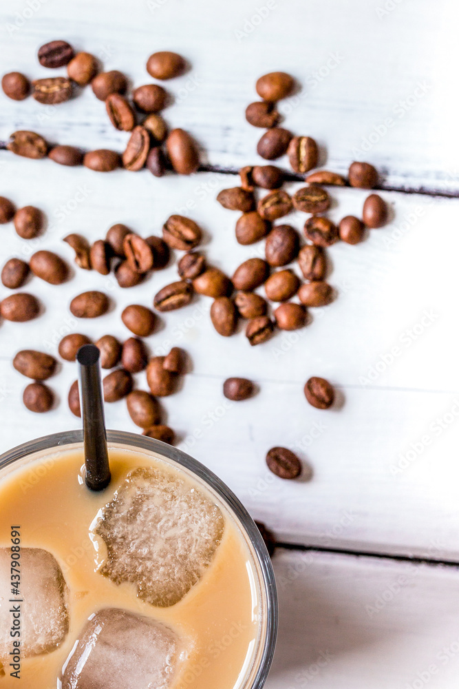 iced coffee with beans for cold summer drink on white background top view