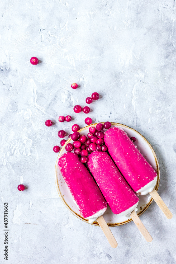 red berries with ice-cream on stone desk background top view mock-up