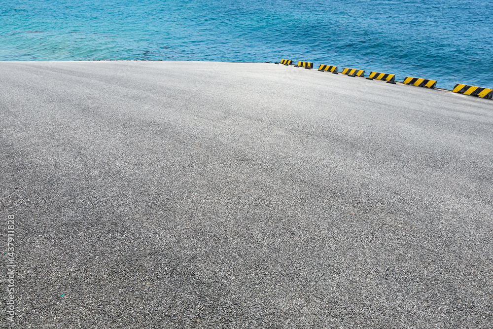 Asphalt road pavement and sea water background.high angle view.