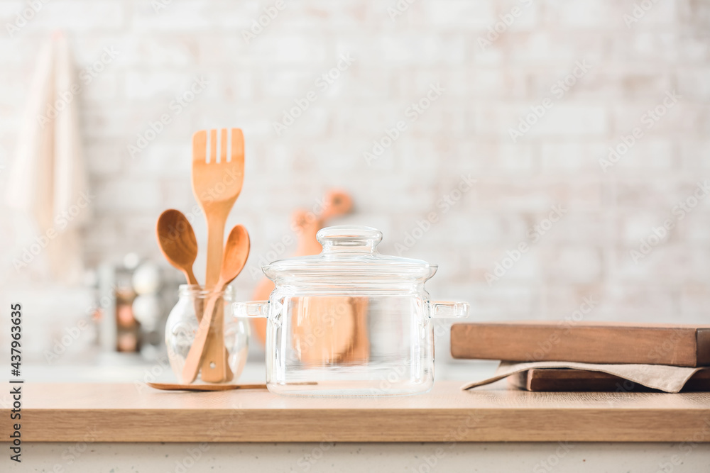 Stylish cooking pot on table in kitchen