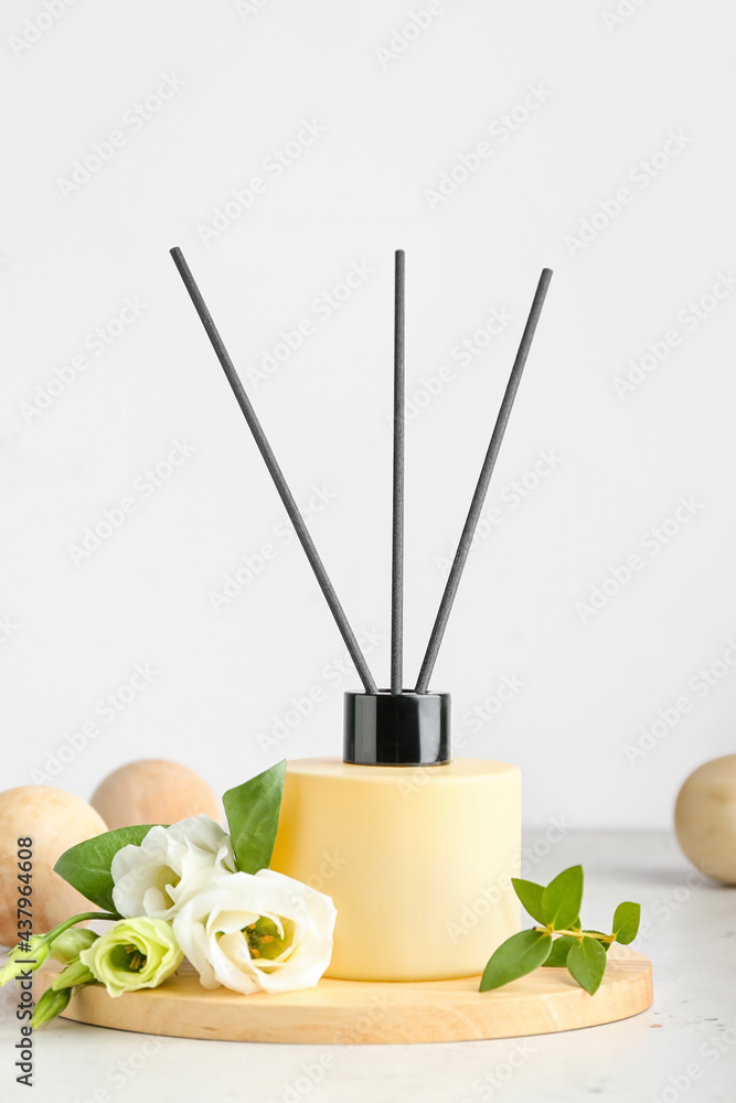 Reed diffuser with eustoma on white background