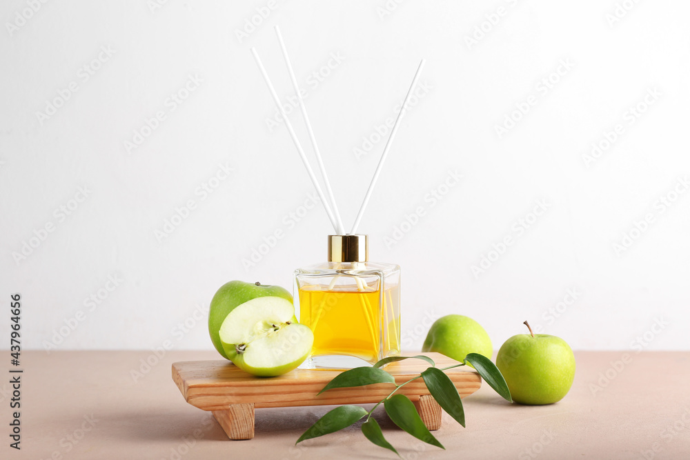 Reed diffuser with apples on table