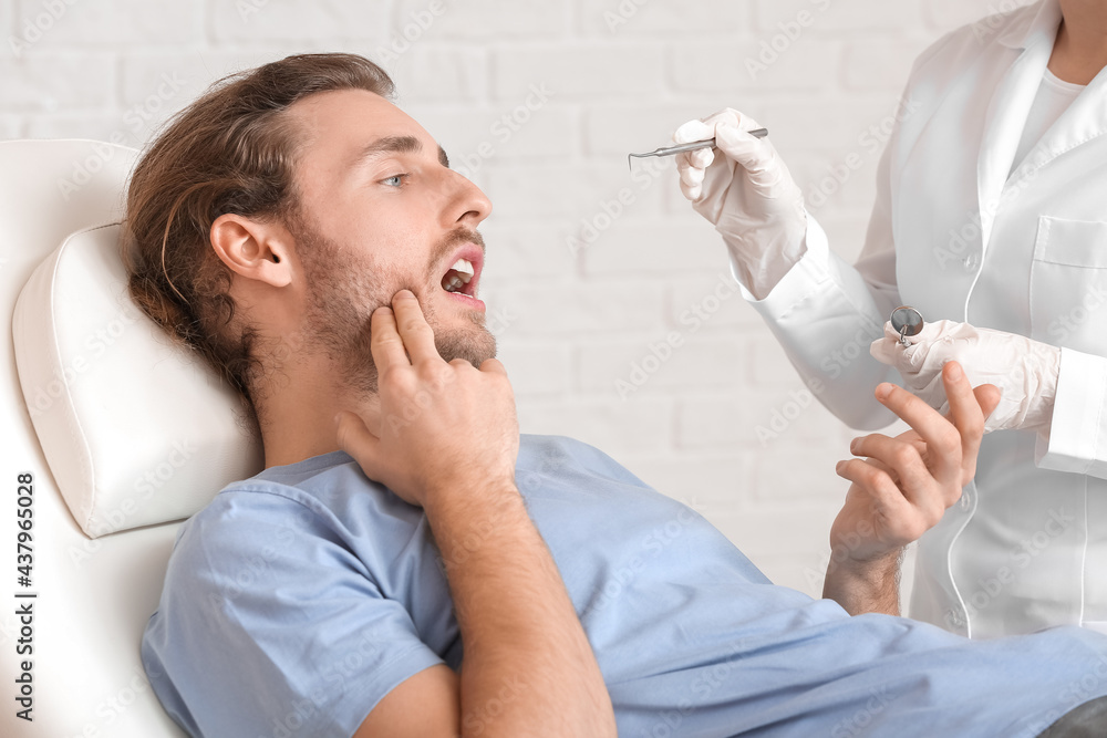 Young man visiting dentist in clinic