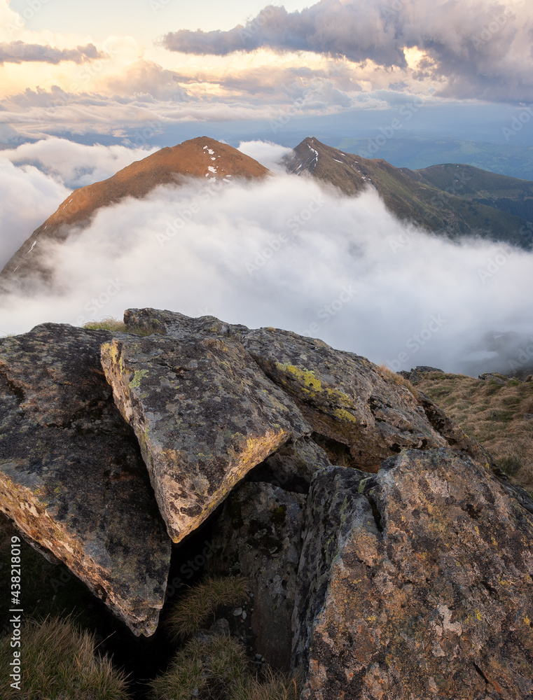 Sunny evening in the mountains. Beautiful mountain landscape with big rocks and a mountain ridge wit