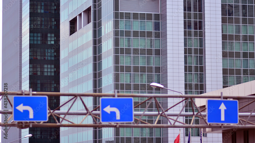 Abstract closeup of the glass-clad facade of a modern building covered in reflective plate glass. Ar