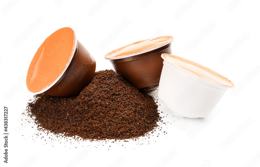 Coffee capsules with powder on white background