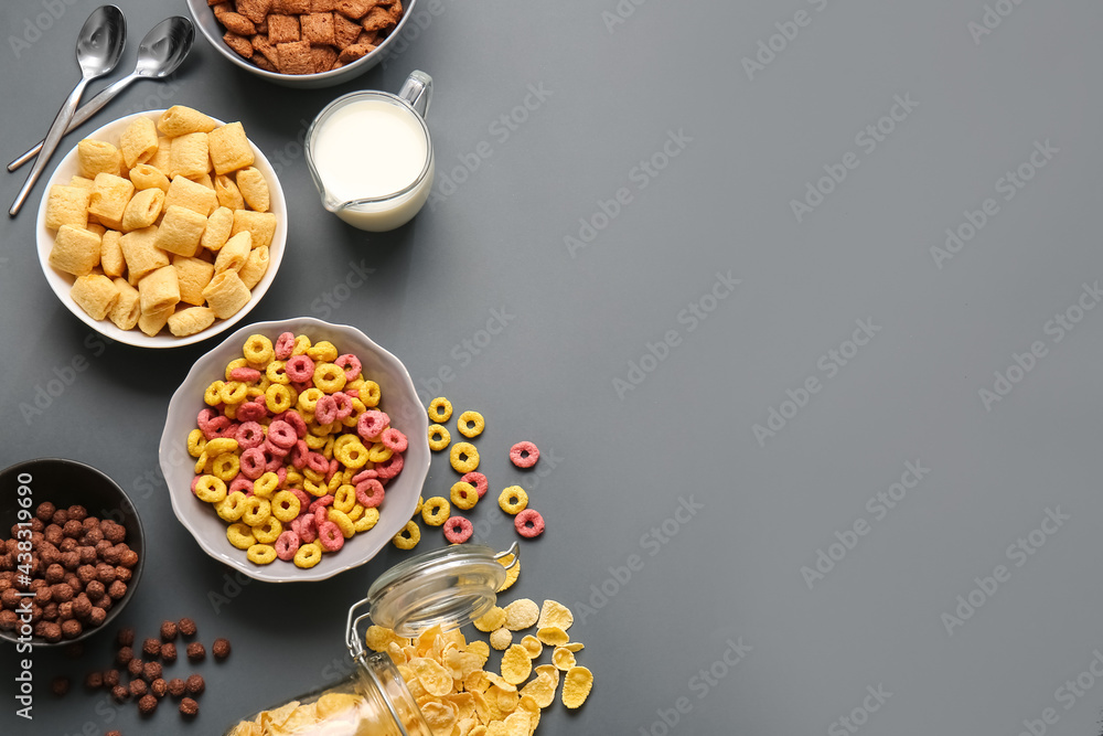 Different cereals and milk on dark background