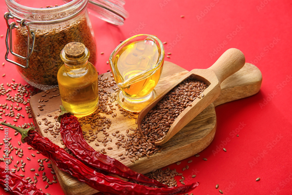 Composition with flax seeds, oil and chili peppers on color background