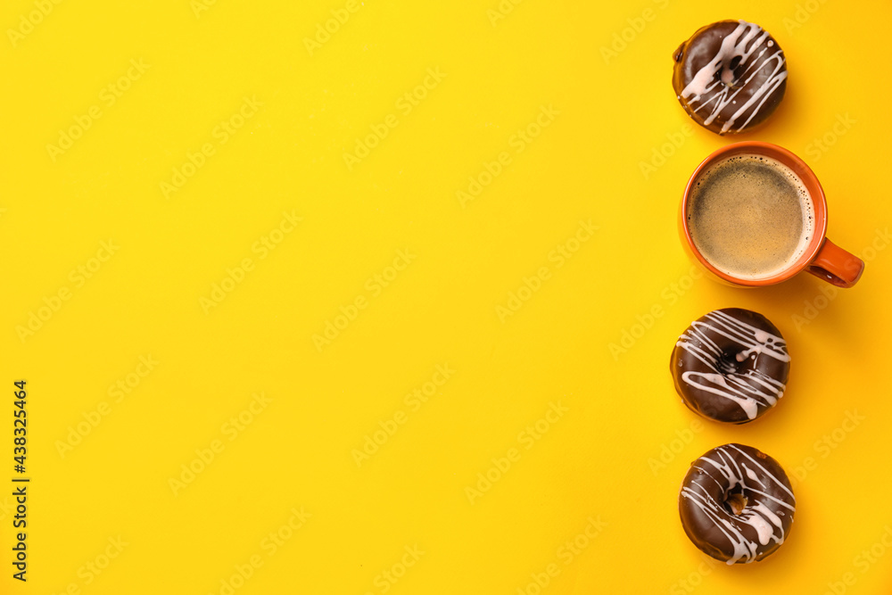 Composition with cup of coffee and donuts on color background