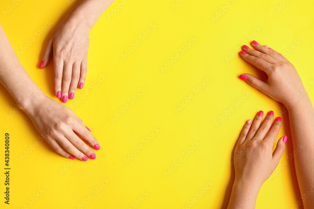 Frame made of female hands with beautiful manicure on color background