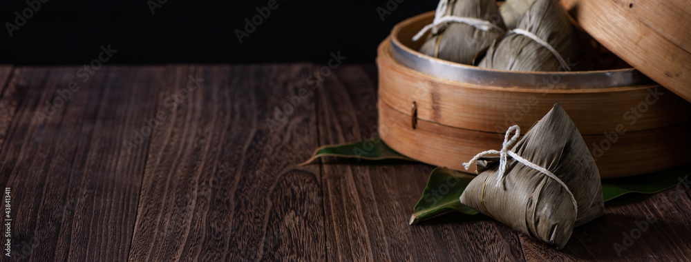 Zongzi. Rice dumpling for Dragon Boat Festival on dark wooden table background.