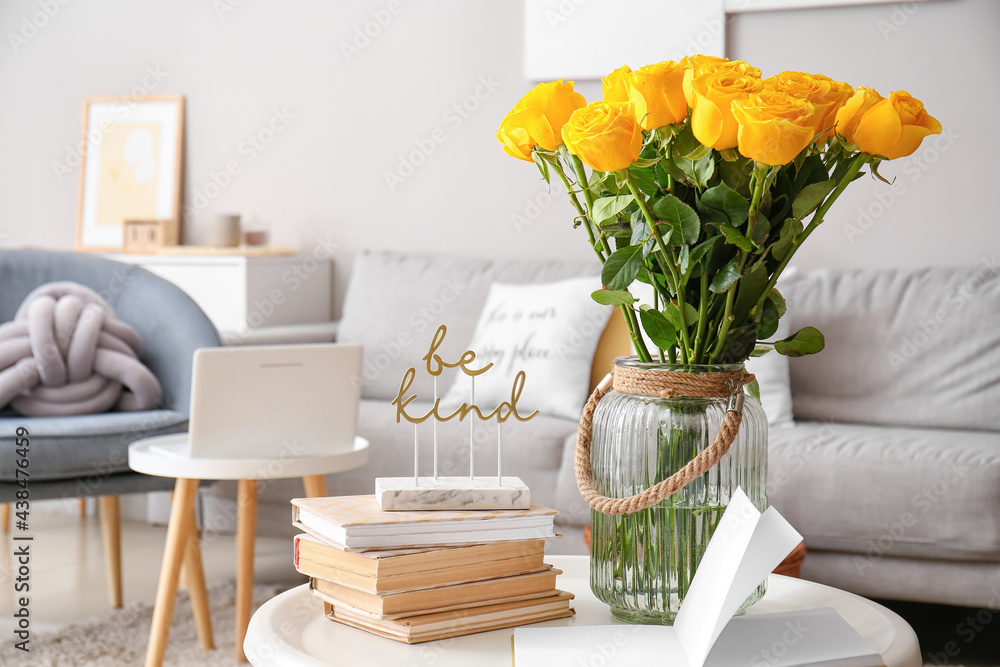 Vase with yellow roses in interior of living room