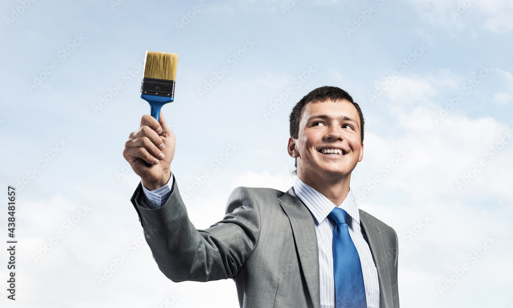 Creative businessman painter holding paintbrush