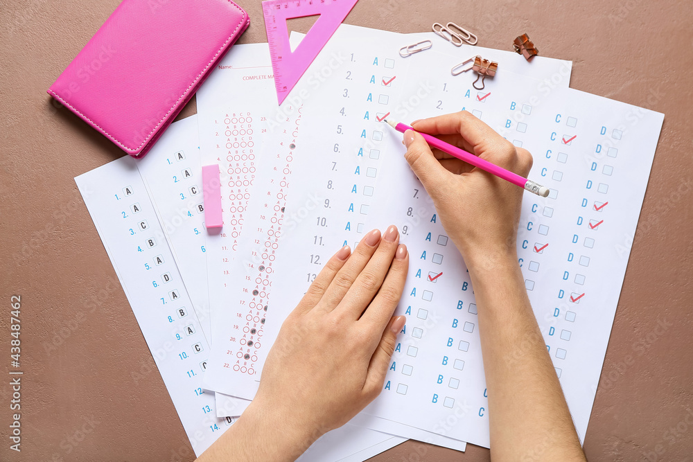 Student passing school test on color background