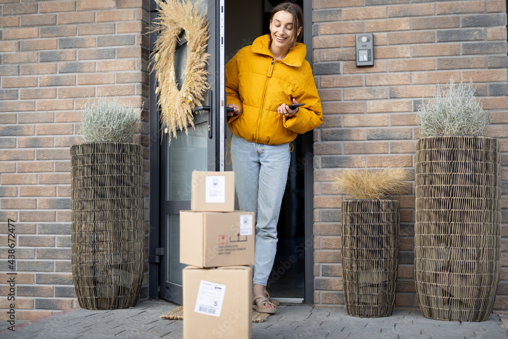 Parcels on the porch in front of the front door. Housewife receiving goods purchased online. Concept