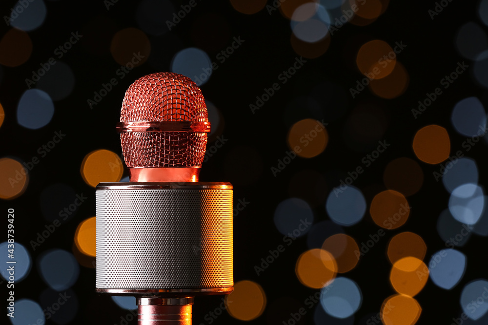 Modern microphone against defocused lights, closeup