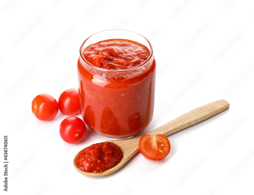 Glass jar of tasty tomato sauce on white background