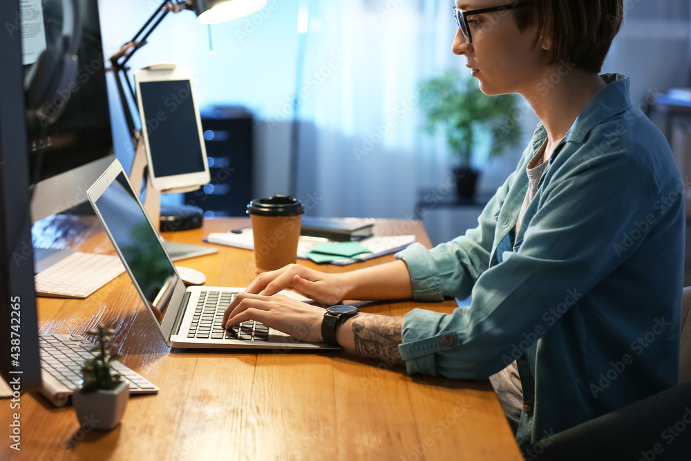 Female programmer working in office at night