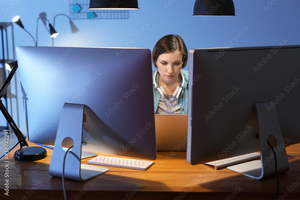 Female programmer working in office at night