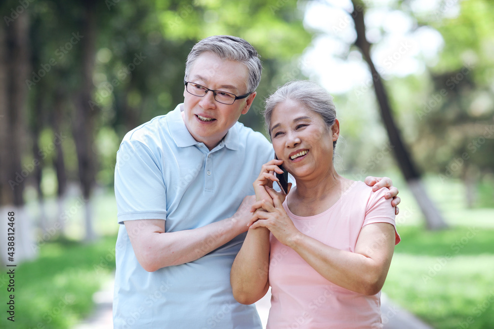 Happy old couples use mobile phones to make calls outdoors