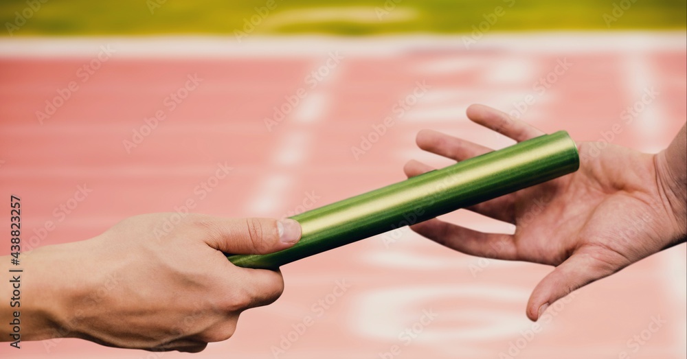 Composition of caucasian athletes passing green relay baton over racing track background