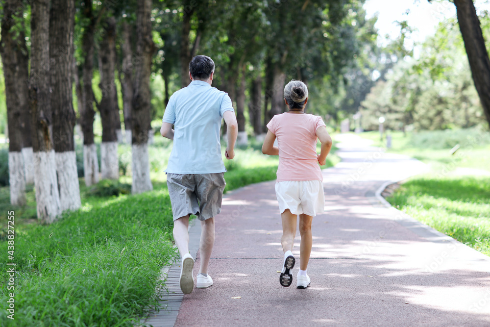 Old couple jogging in outdoor park