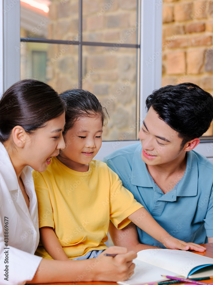 Young parents help their children with their homework