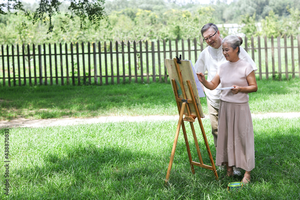 幸福的老夫妇在公园里画画