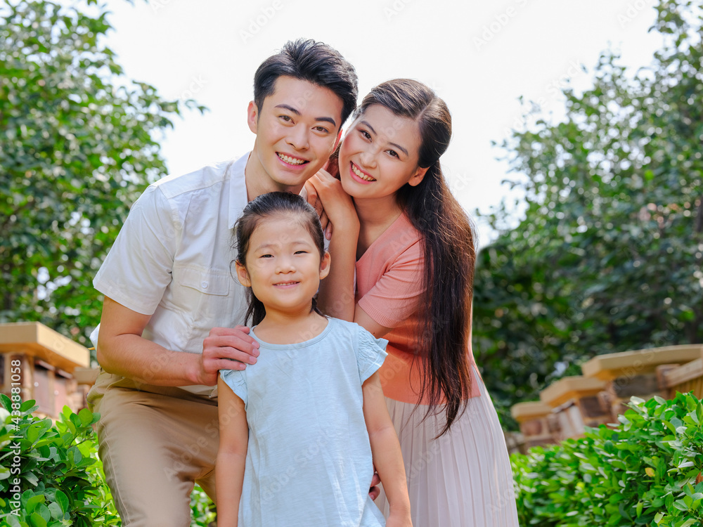 Happy family of three in the outdoor group photo