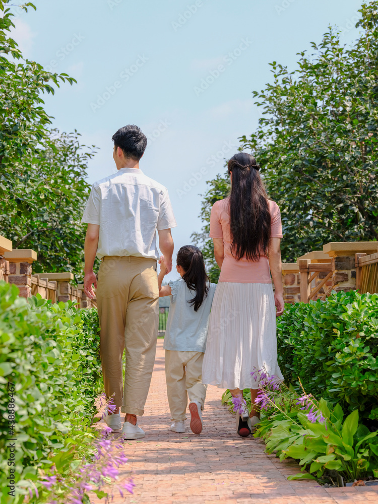 A happy family of three walking outdoors