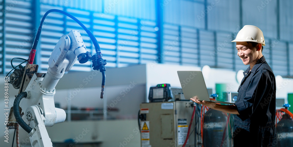 Engineer working with industrial 4.0 technology in factory. with robot arm machine. Futuristic innov