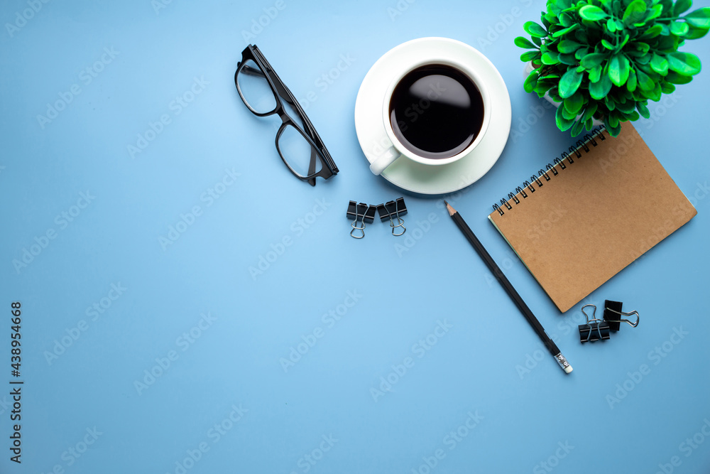 Flat lay, top view office table desk. Workspace with, laptop,office supplies, pencil, green leaf, an