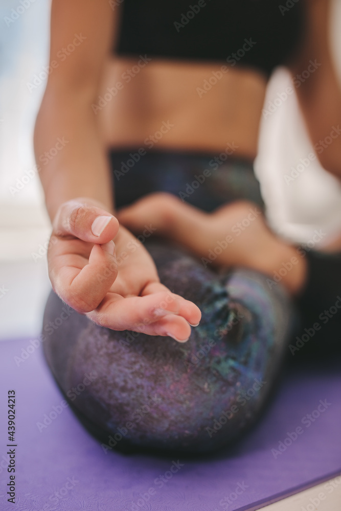 Woman hand sitting in lotus pose