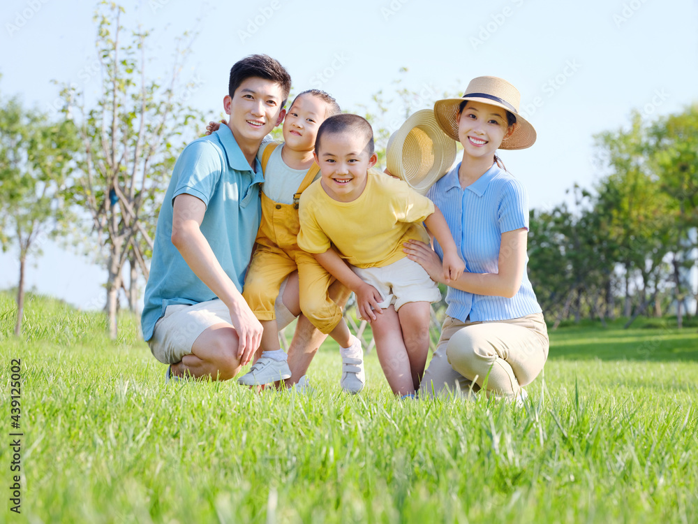 Happy family of four in the outdoor group photo