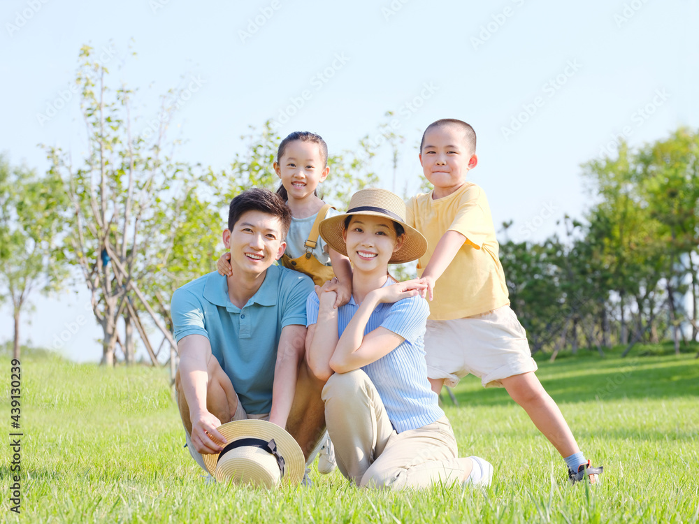 Happy family of four in the outdoor group photo