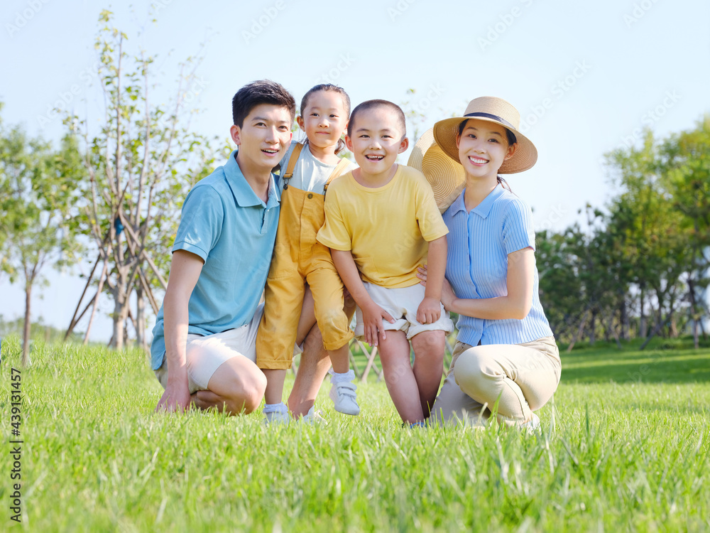 Happy family of four in the outdoor group photo