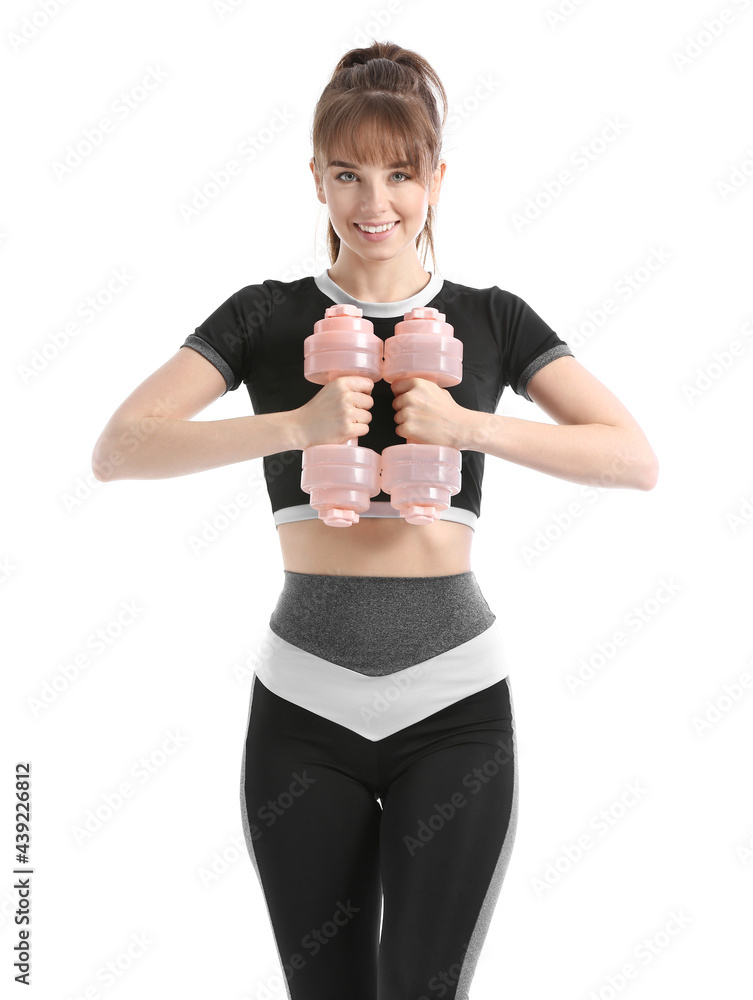 Sporty young woman with dumbbells on white background