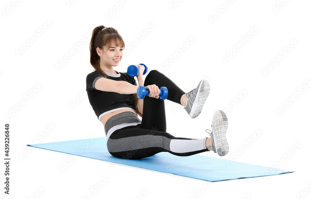 Sporty young woman training with dumbbells on white background