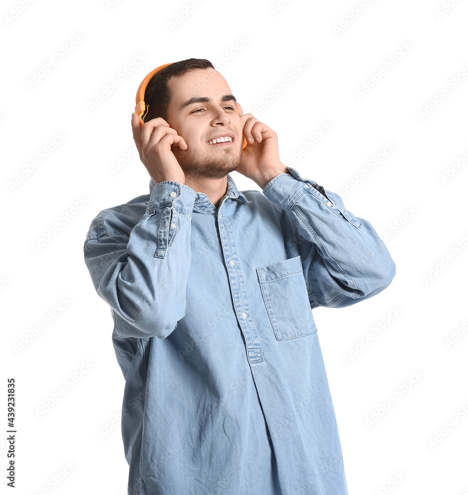 Handsome man listening to music on white background