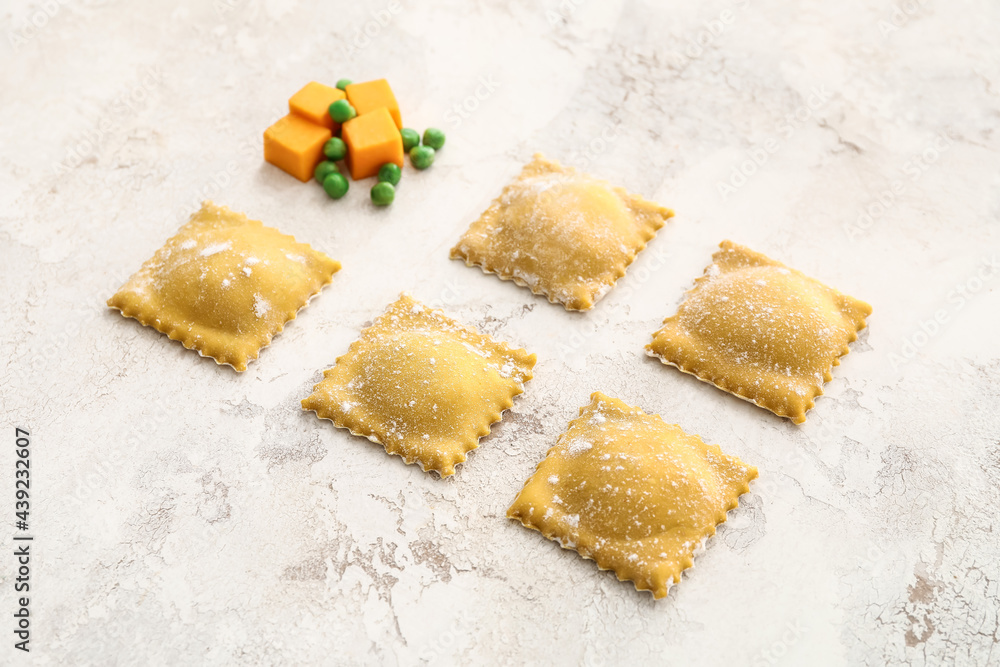 Raw ravioli on light background