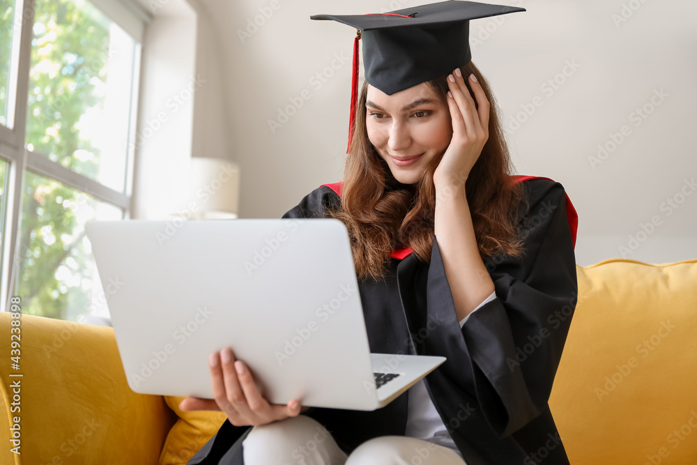 Happy female student on her graduation day at home. Concept of studying online