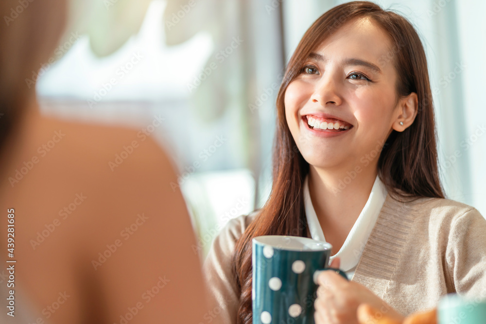 attractive asian female talking good positive conversation to friends with smiling laugh and happine