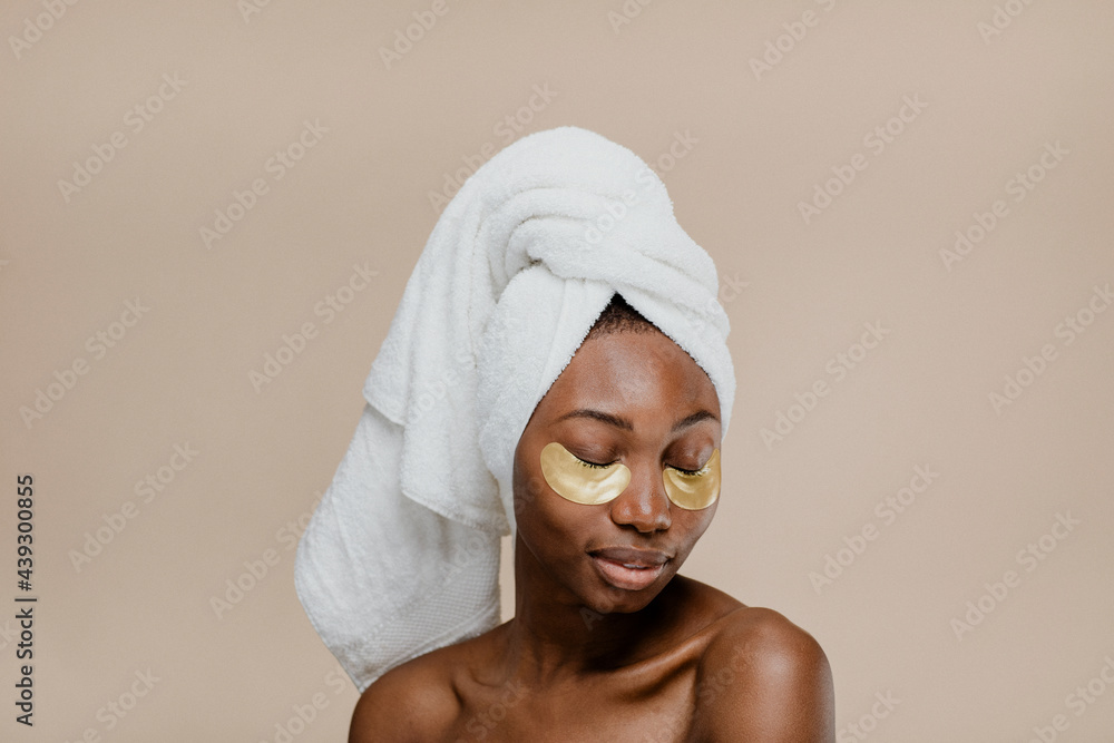 Black woman wearing a golden eye mask