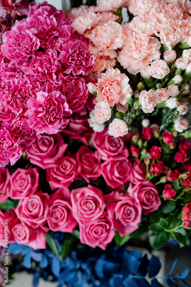 Pink and peach carnations with pink roses in a flower shop