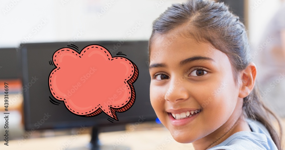 Composition of schoolgirl in classroom smiling to camera, with empty red speech bubble