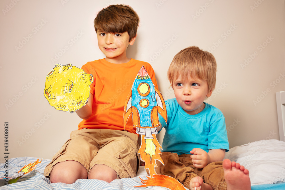 Two boys play astronauts and rocker liftoff