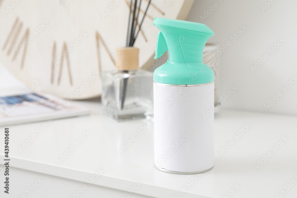 Bottle of air freshener on shelf in room, closeup