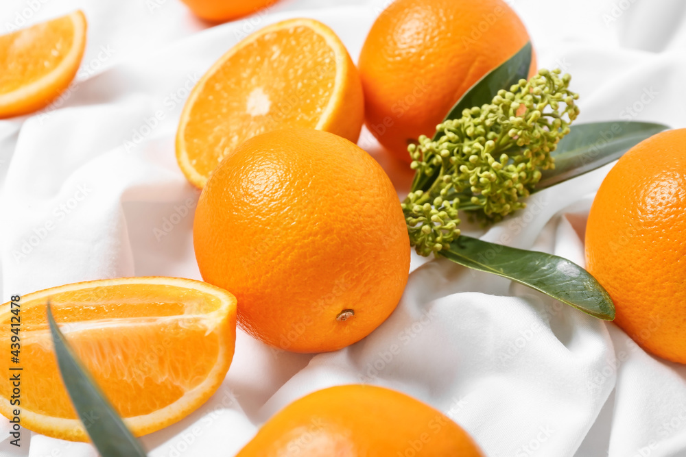 Juicy oranges on fabric background, closeup